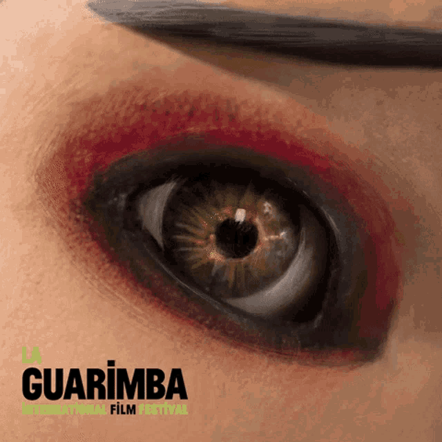 a close up of a woman 's eye with the words guarimba international film festival on the bottom