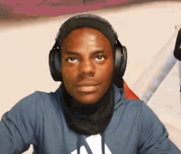 a young man wearing headphones and a scarf around his neck .
