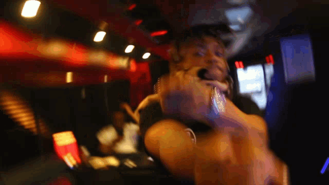 a blurry picture of a man giving a middle finger