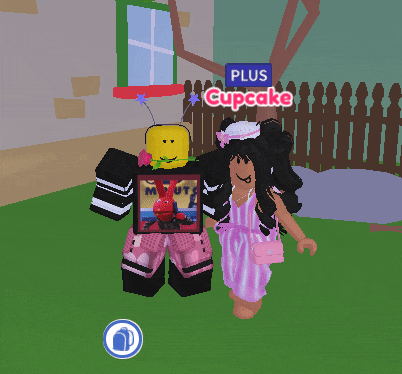 a girl in a pink dress stands next to a boy in a black shirt with a picture of a bunny on it