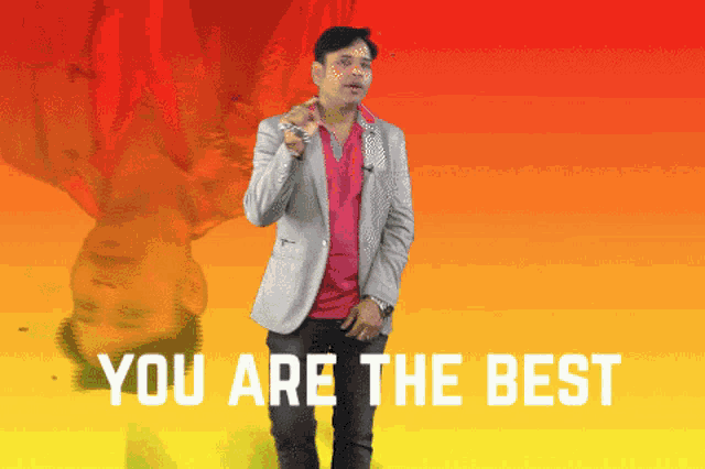 a man in a suit is standing in front of a yellow and red background that says " you are the best "