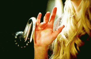 a close up of a woman 's hand with a black background