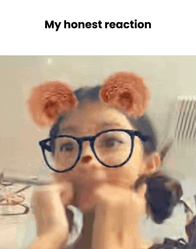 a girl wearing glasses with bear ears is making a funny face .