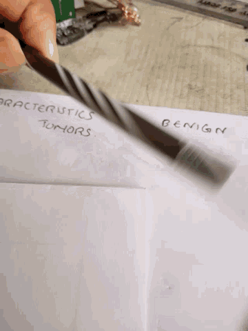 a person is holding a pair of scissors in front of a piece of paper that says " plastics of designers "
