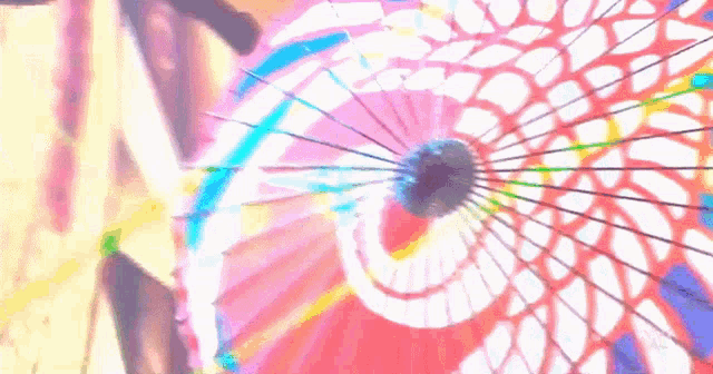 a close up of a colorful umbrella with a rainbow design