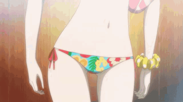 a woman in a bikini with a bracelet on her wrist