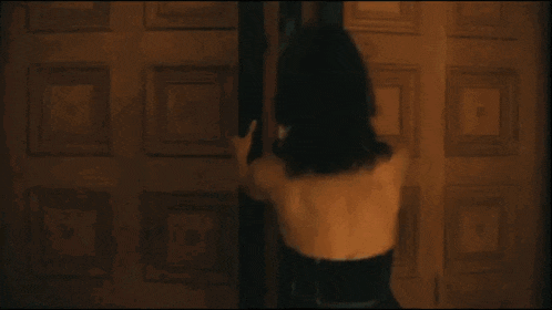 a man and a woman are standing next to each other in a room .