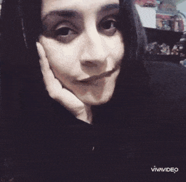 a woman 's face is shown with the letters a and a in the corner