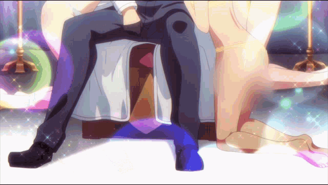 a man in a suit sits next to a woman in a purple dress