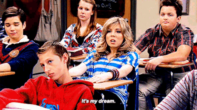 a girl in a striped shirt says it 's my dream in a classroom