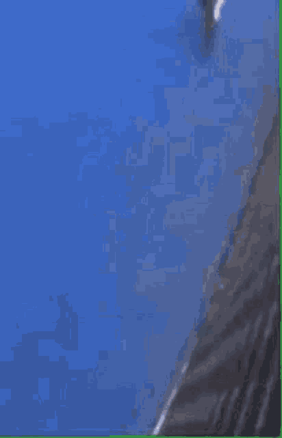 a person is laying on their stomach on a blue surface .