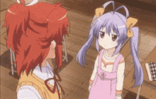 a girl with purple hair is standing next to a girl with red hair .