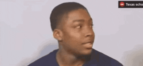a young man is making a funny face with his eyes closed and his mouth open .