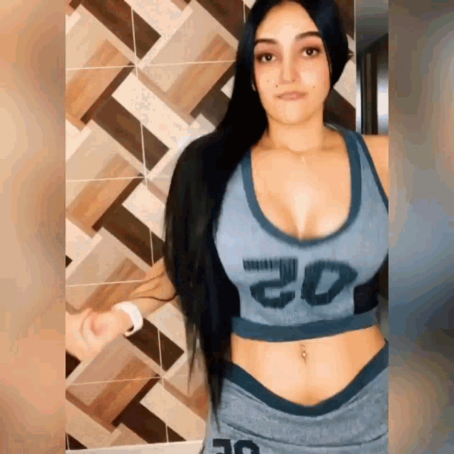 a woman in a crop top with the number 20 on the front