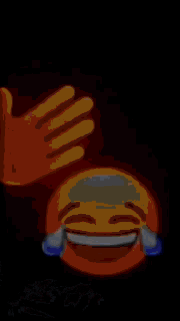 a hand is holding a picture of a smiley face with the letter s on it