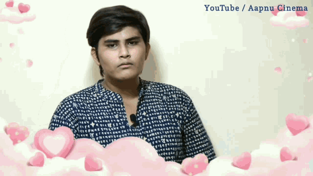 a young man is surrounded by pink hearts and the words youtube / aapnu cinema on the bottom