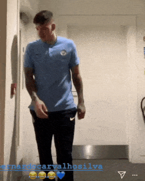a man in a blue shirt is standing in a hallway with the name fernando carvalhosilva on the bottom right