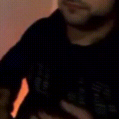 a blurry picture of a man wearing a black shirt with the word gap on it