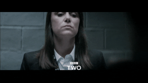 a woman in a suit and white shirt with bbc two on the bottom right