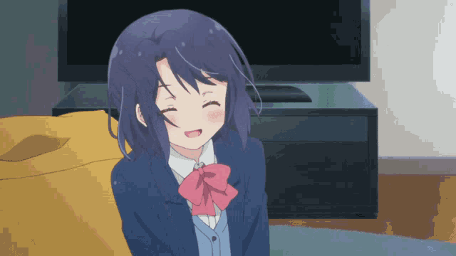a girl with blue hair is sitting in front of a television