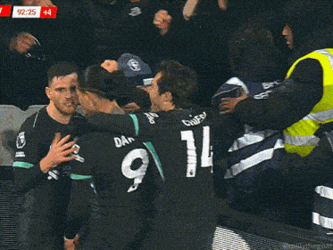 a group of soccer players are hugging each other and salah is wearing number 11