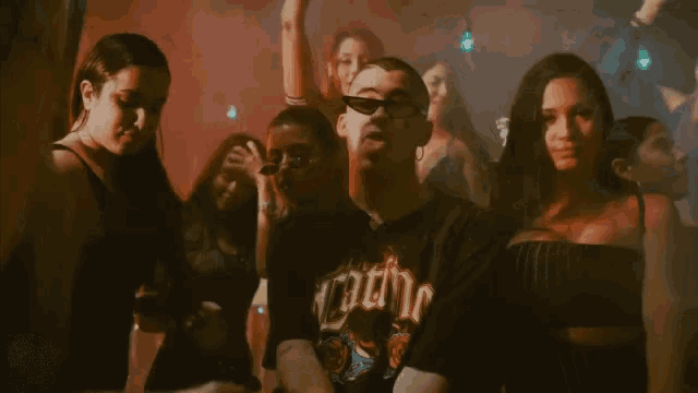 a group of people are dancing in a club and one of them is sticking out his tongue .