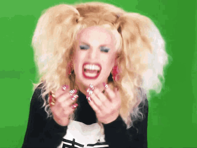 a woman with blonde hair and red nails is screaming