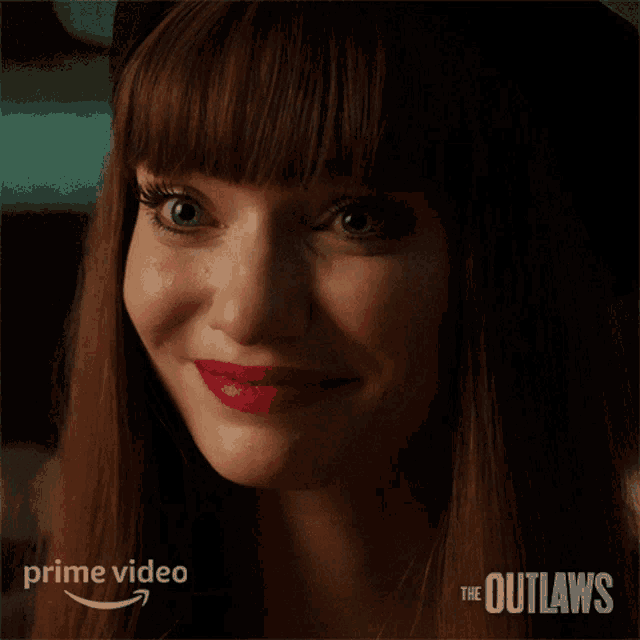 a close up of a woman 's face with the words " the outlaws " on the bottom right