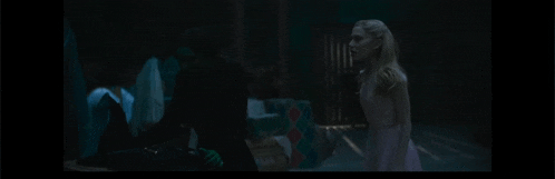 a woman in a white dress is standing in a dark room with the words " i hope you 're happy now " on the bottom