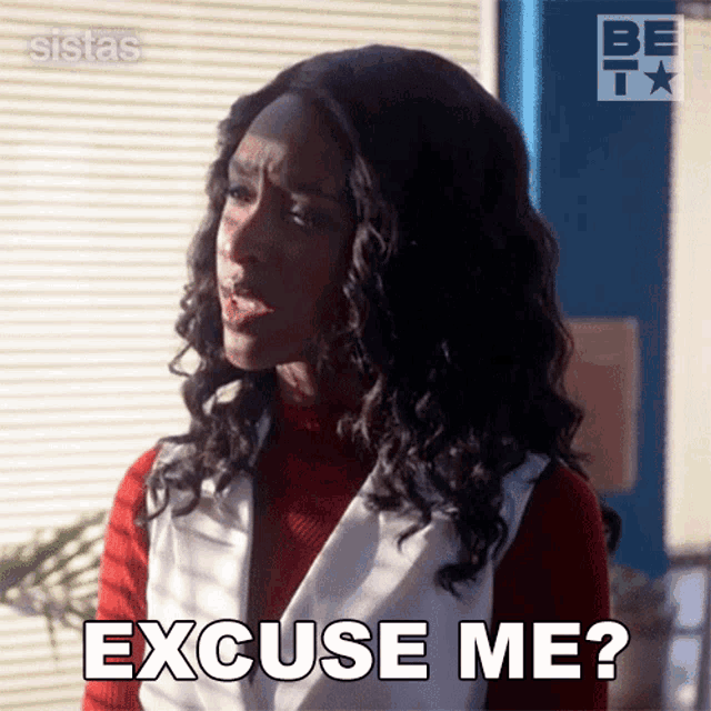 a woman with curly hair is making a funny face and says " excuse me "