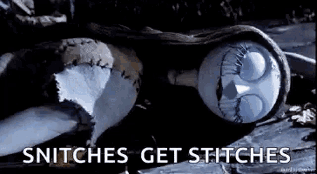 sally from the nightmare before christmas is laying on the ground with stitches on her face .