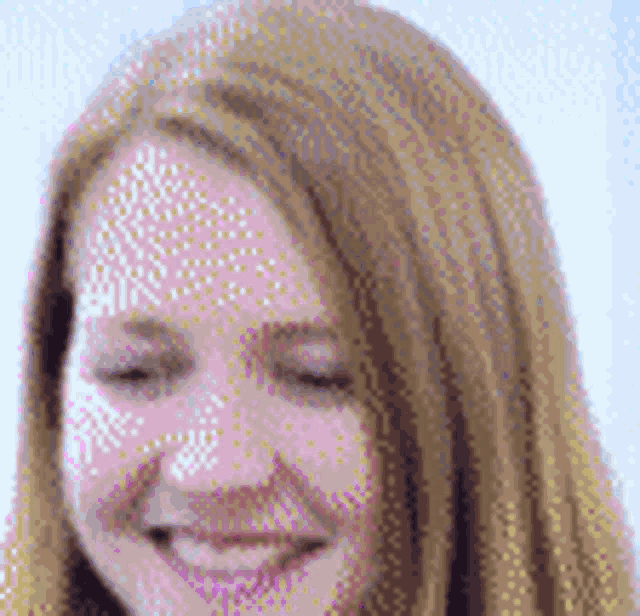 a close up of a woman 's face with her eyes closed smiling .
