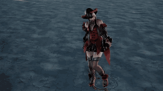 a woman in a red and black dress is walking in the water
