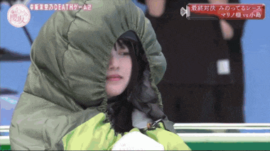 a girl is wearing a green jacket with a hood