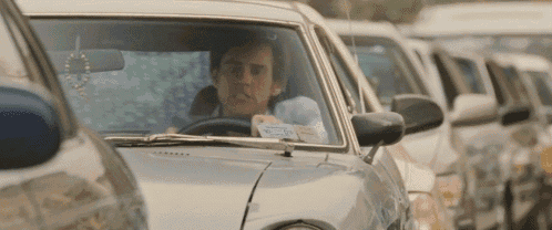 a man is driving a car with a license plate that says ' a ' on it