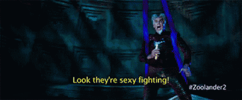 a movie poster for zoolander 2 shows a man holding a microphone and saying " look they 're sexy fighting "