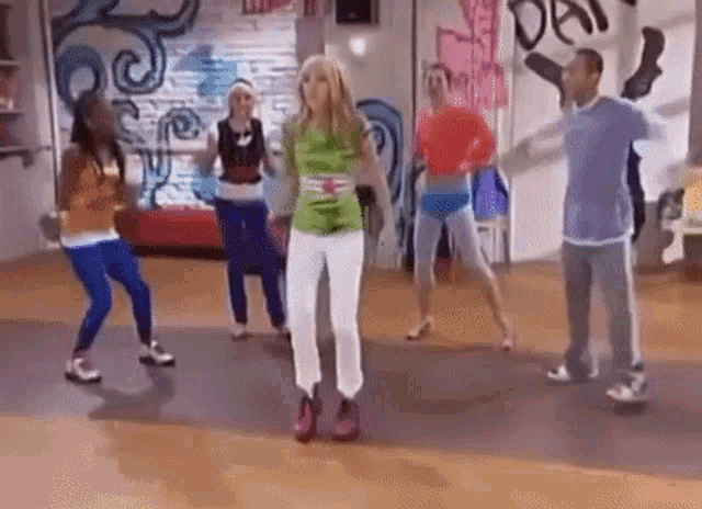 a group of young people are dancing together in a dance studio .