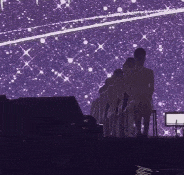 a group of people are standing on a stage in front of a purple background