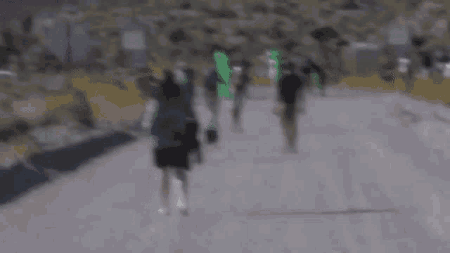 a blurry photo of people walking down a road