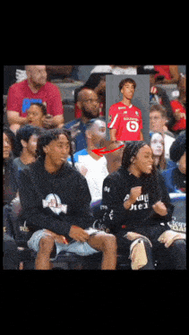 a man in a red vodafone jersey sits in the stands