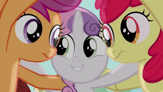 three ponies are standing next to each other and looking at each other