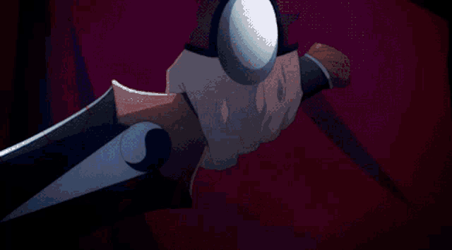 a close up of a person 's hand holding a ball in the dark .