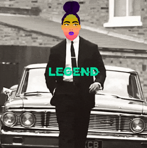 a man in a suit and tie is standing in front of a car with legend written on it