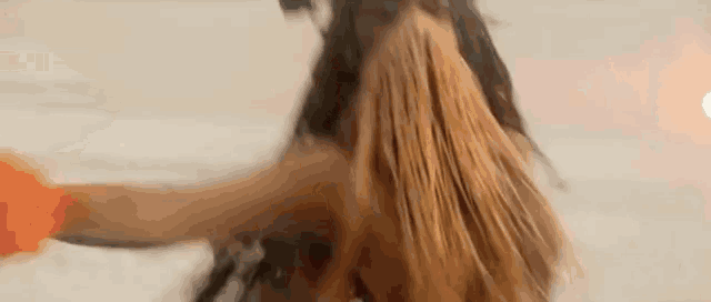 a close up of a woman 's hair in a blurry photo .