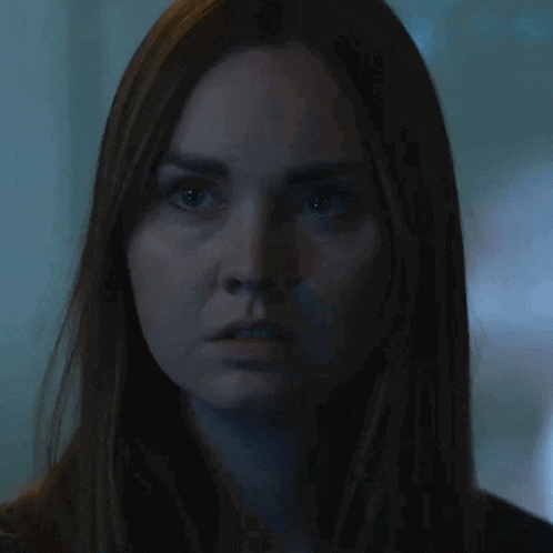 a woman in a dark room has the word no written on her face