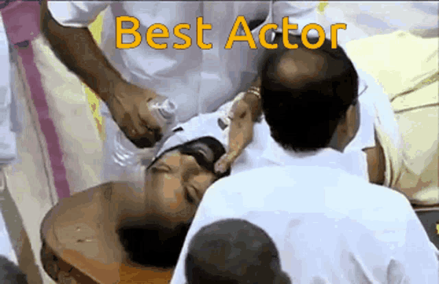a man is laying on a stretcher with the words best actor on the bottom