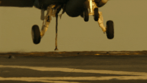 a plane is taking off from a runway and the landing gear is visible
