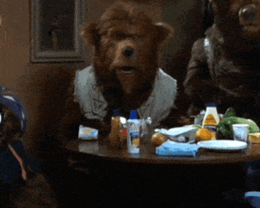 a teddy bear sitting at a table with the word that written on it