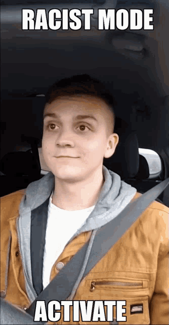a man sitting in a car with a racist mode activated meme