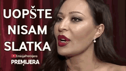 a close up of a woman 's face with the words uopste nisam slatka written above her